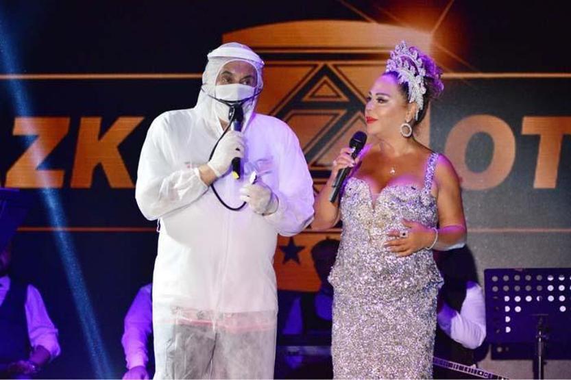 Faik Öztürk tulum ve maske ile sahnede