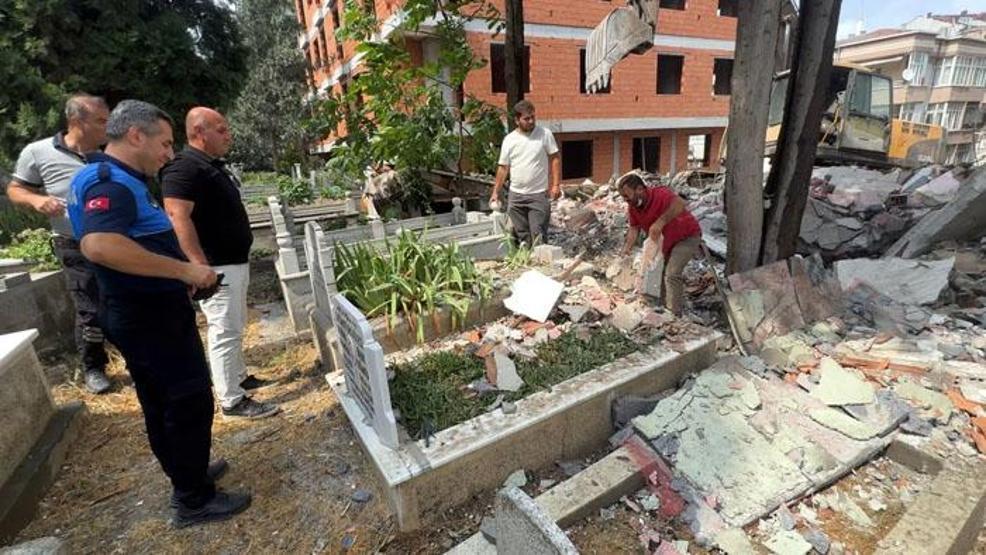 Yıkılan binadan mezarlığa moloz düşmesin diye yastıklı önlem