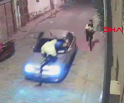 Kendisini durdurmaya çalışan polisi, aracının kaputunda götürdü | Video Haber
