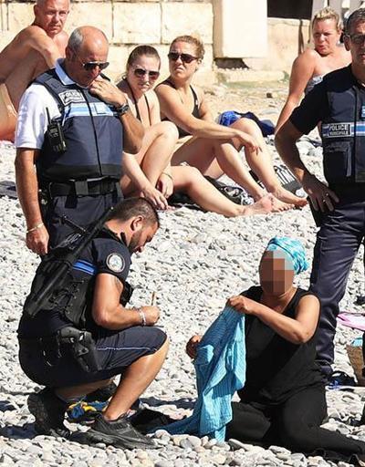 Fransız polisi plajda burkini giyen kadını soyunmaya zorladı